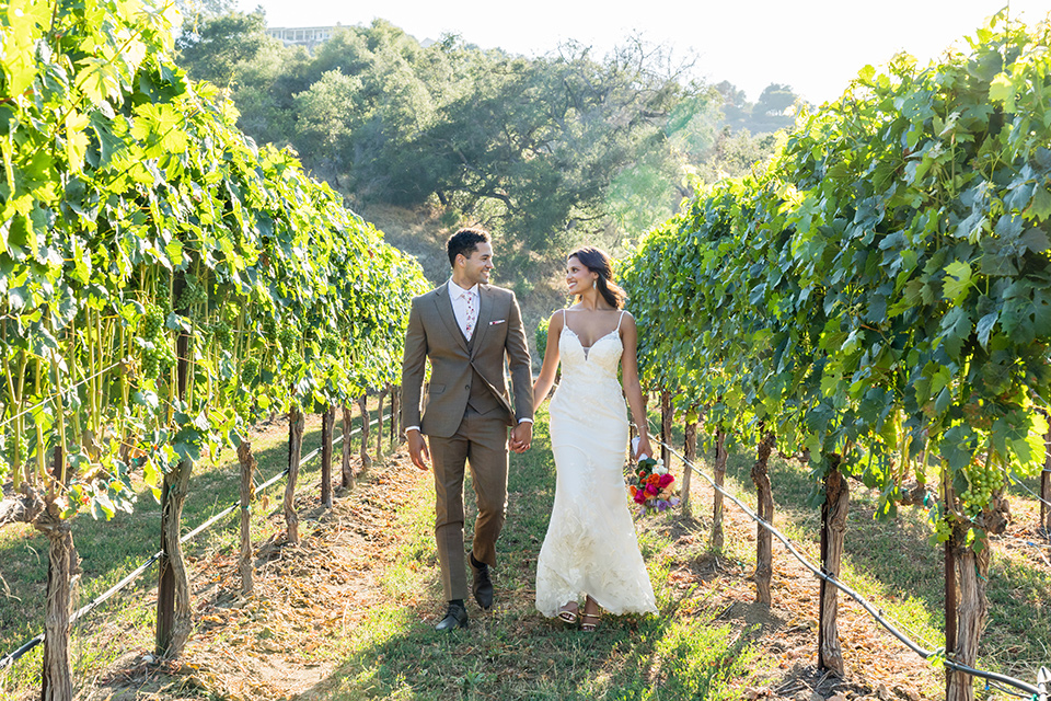 couple walking through a winery on their wedding day