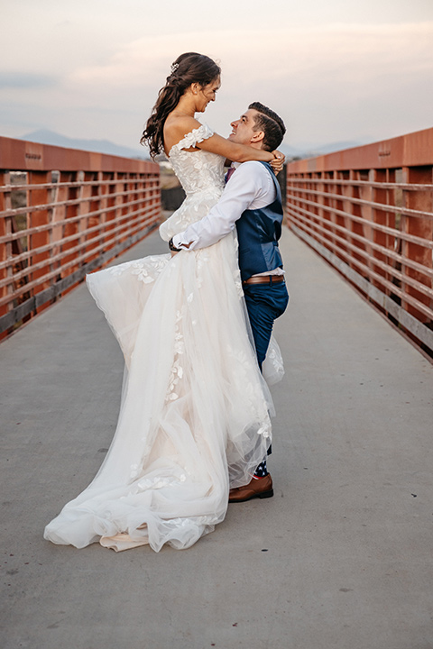 couple on the sand taking wedding photos