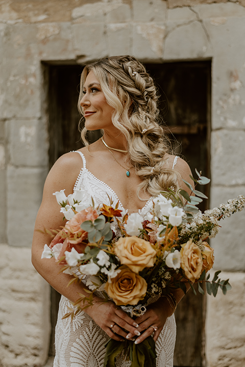 Bride in a stunning white wedding dress posing elegantly outdoors
