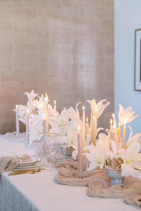 A sophisticated wedding tablescape featuring crystal glassware, gold accents, and ivory floral arrangements, set against the timeless elegance of the US Grant House.