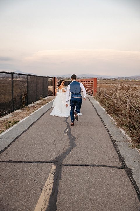 couple on the sand taking wedding photos