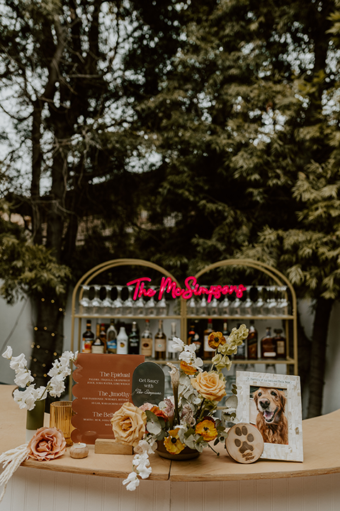 Warm and inviting rustic boho wedding reception setup with wooden tables, candles, and floral centerpieces, creating a cozy, intimate atmosphere