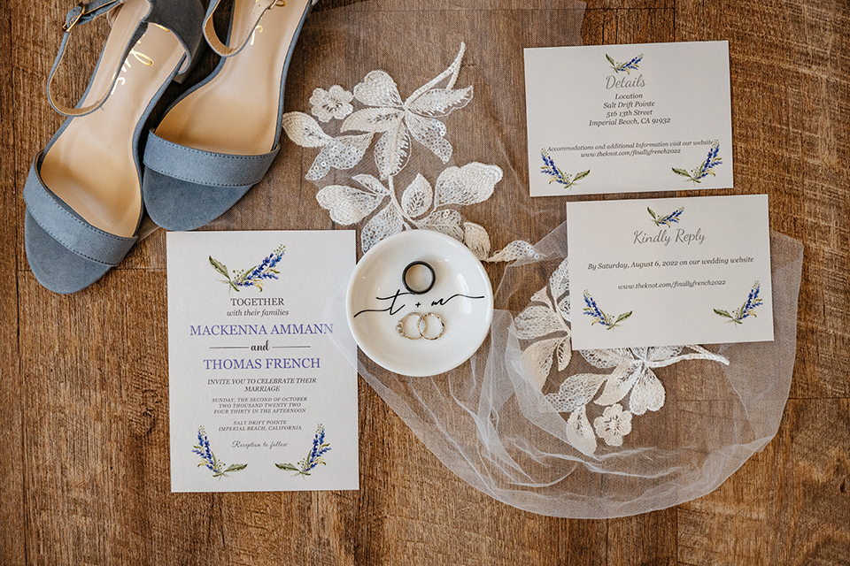 white and light blue invitations and bridal shoes