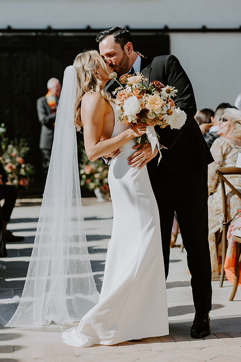 bride and groom kiss