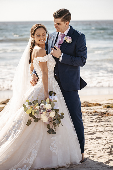 couple on the sand taking wedding photos