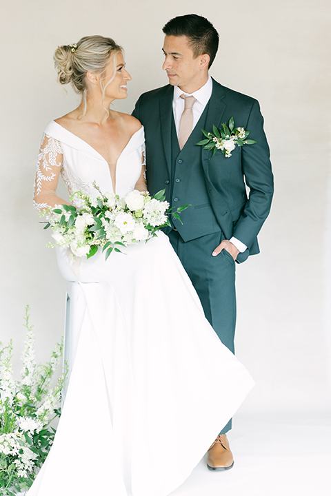 Minimalist wedding decor featuring archway backdrops with cascading greenery.