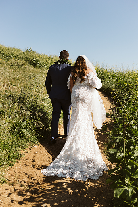 Bride and groom walking down path