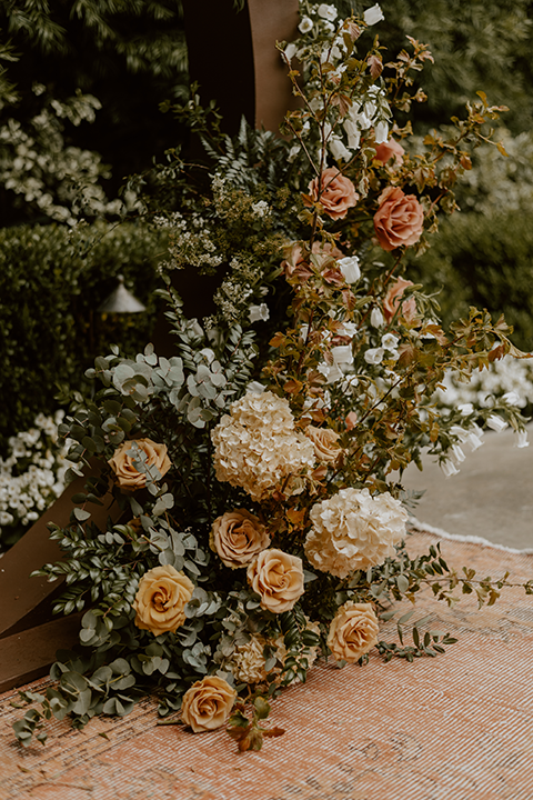 Delicate floral arrangements featuring wildflowers, greenery, and soft tones, adding a rustic boho charm to the wedding decor