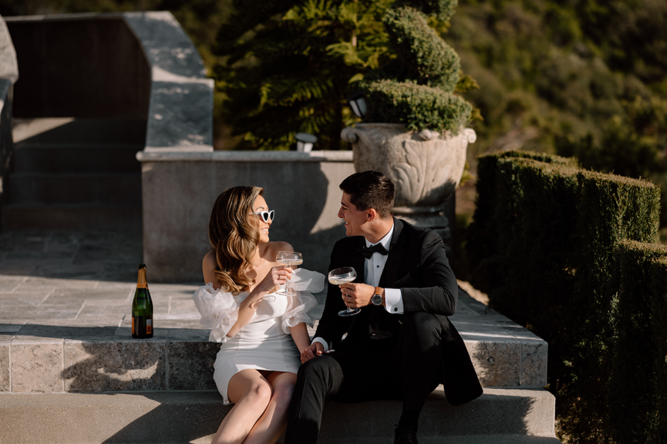 Bride and groom sitting on stairs