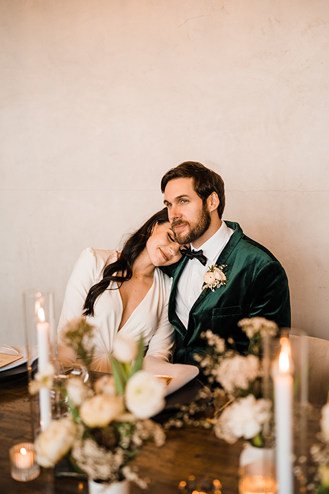 Bride and groom share a romantic moment on the runway at Hangar 21, with golden-hour lighting and a stunning white rose bouquet.