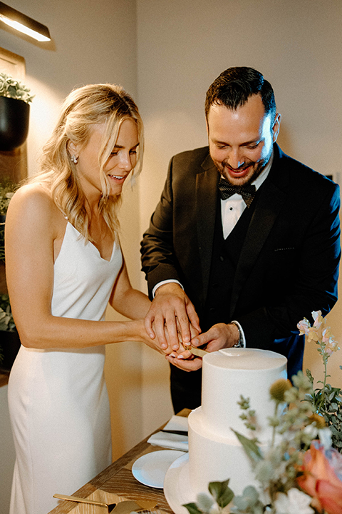 bride and groom cutting the cake