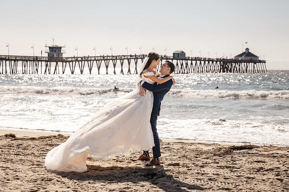 couple on the sand taking wedding photos