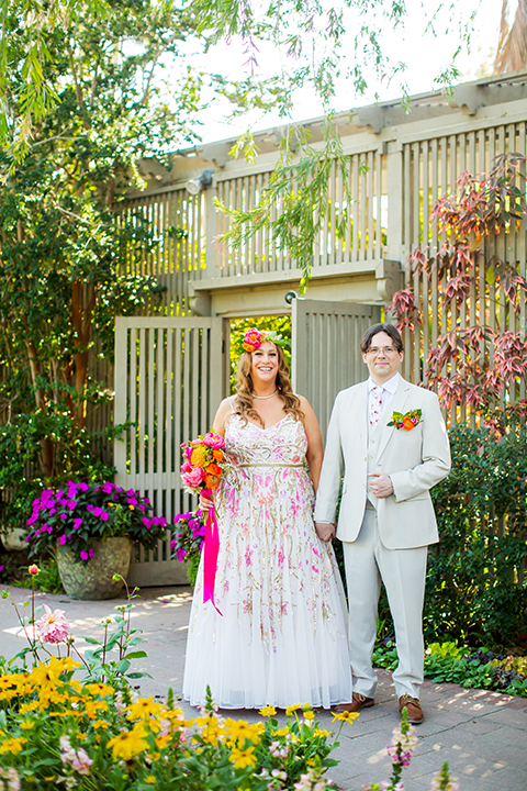 Bride and groom walking down path