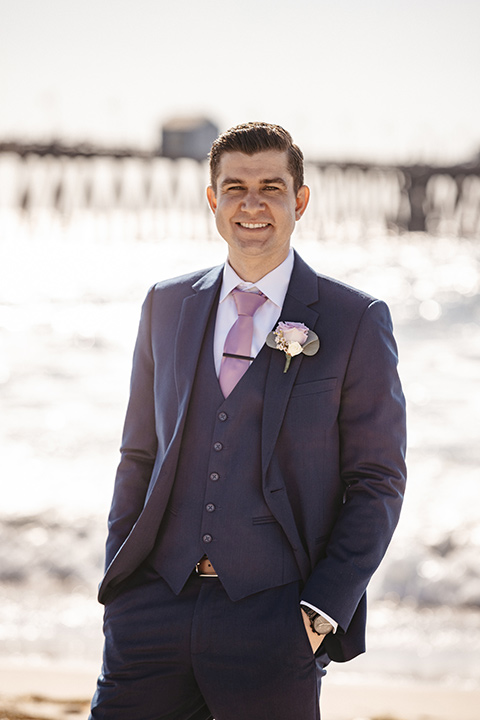 groom in cobalt blue suit and a light pink tie