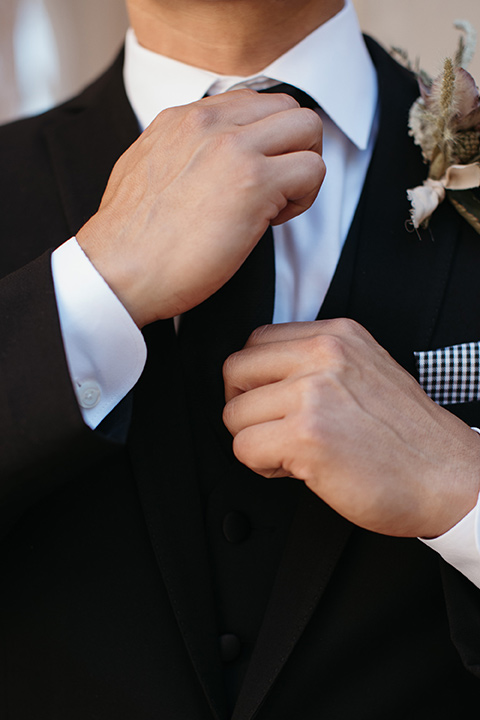 groom in black tuxedo