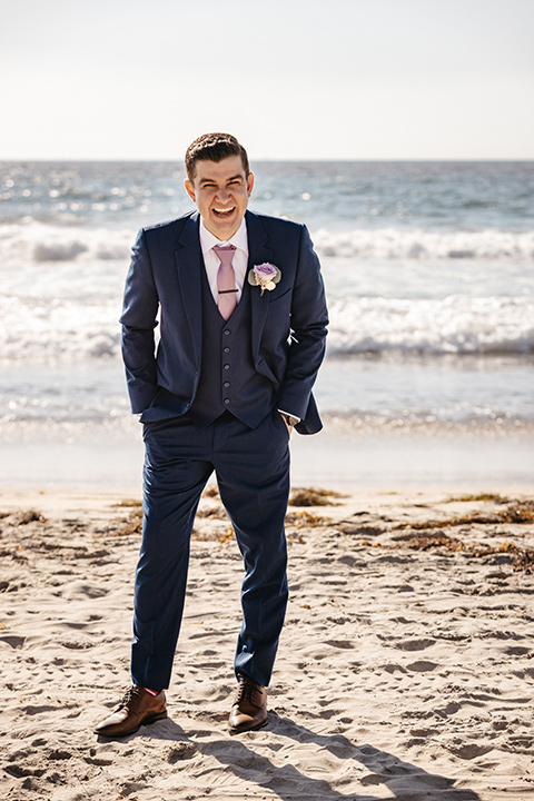 groom in a cobalt blue suit with a pink tie
