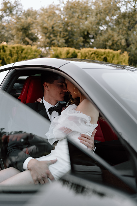 Couple pose in camero