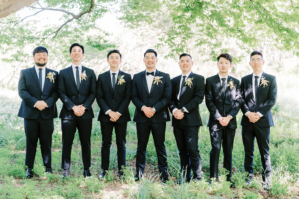 Modern wedding suit styles worn by the groom and groomsmen.
