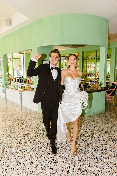 The groom in a classic black tuxedo and bow tie, exuding timeless sophistication.