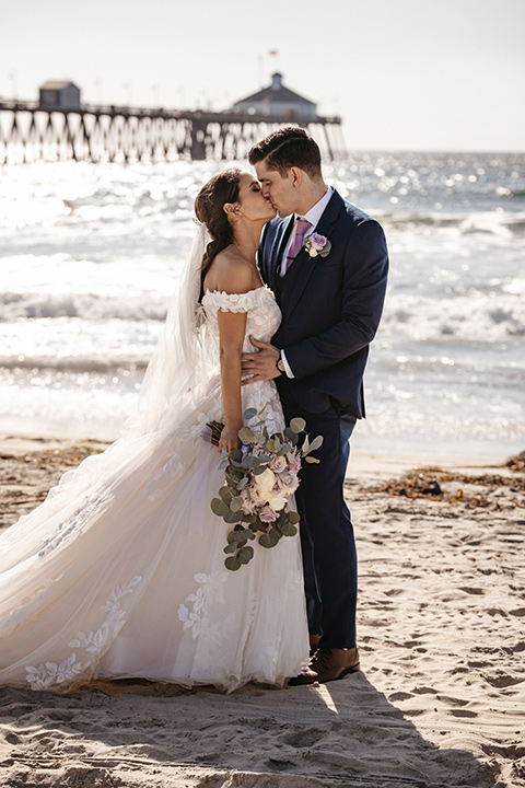 couple on the sand taking wedding photos