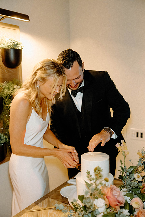 bride and groom cutting the cake