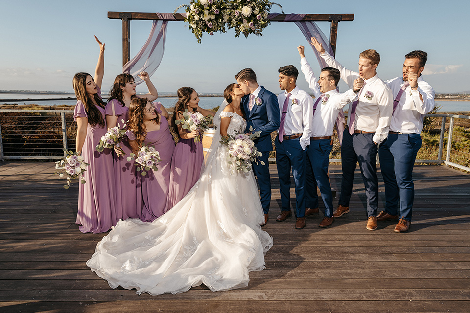 bridal party with the bridesmaids in lilac and the groomsmen in blue