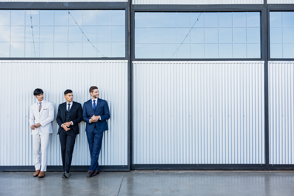 Michael Kors suits worn by three men.
