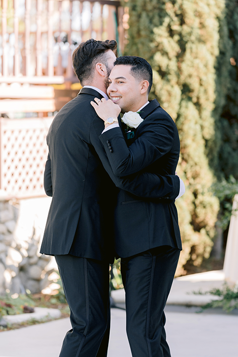 Grooms dancing at reception