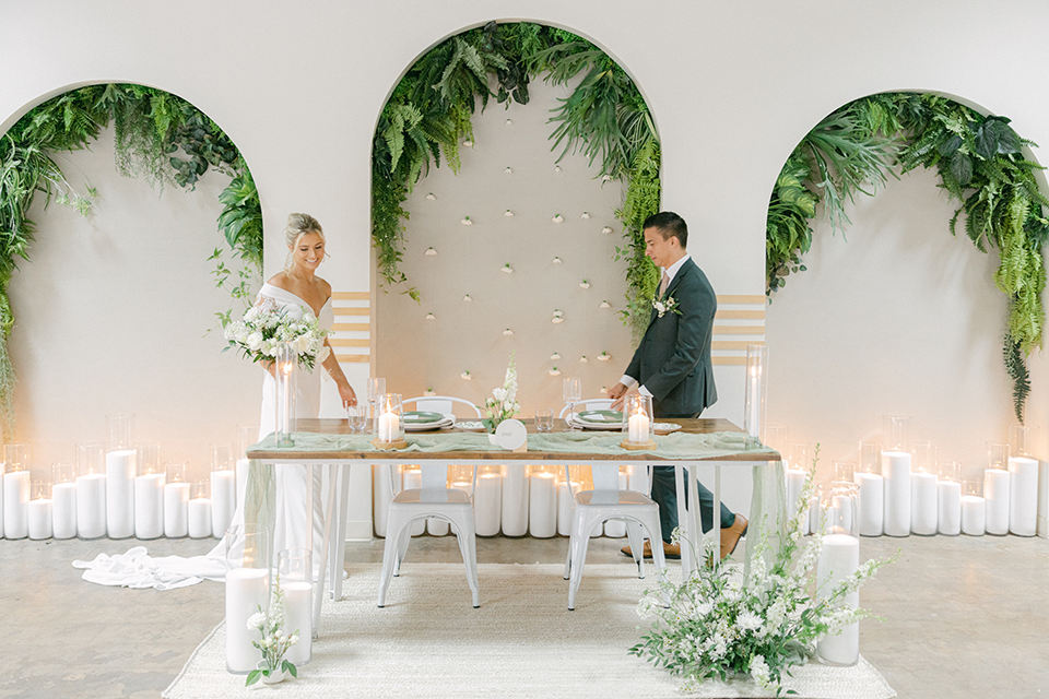bride and groom standing near table