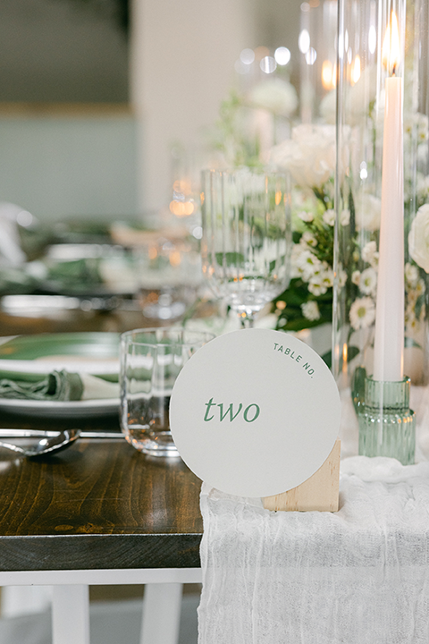 Minimalist wedding decor featuring archway backdrops with cascading greenery