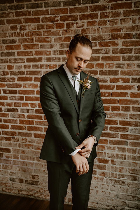 Groom in a stylish suit posing confidently on his wedding day