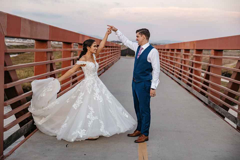 couple on the sand taking wedding photos