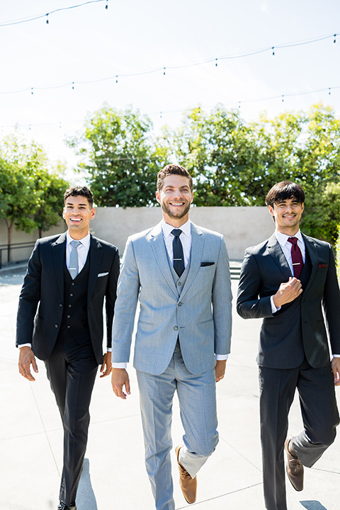 Michael Kors suits worn by three men.